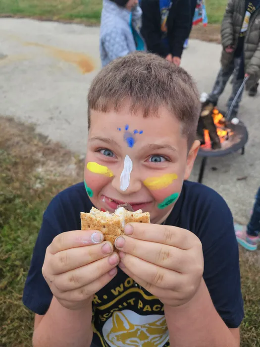 Wyatt enjoying a snack with colorful face paint