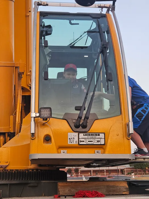 Wyatt sitting inside the cab of a large vehicle