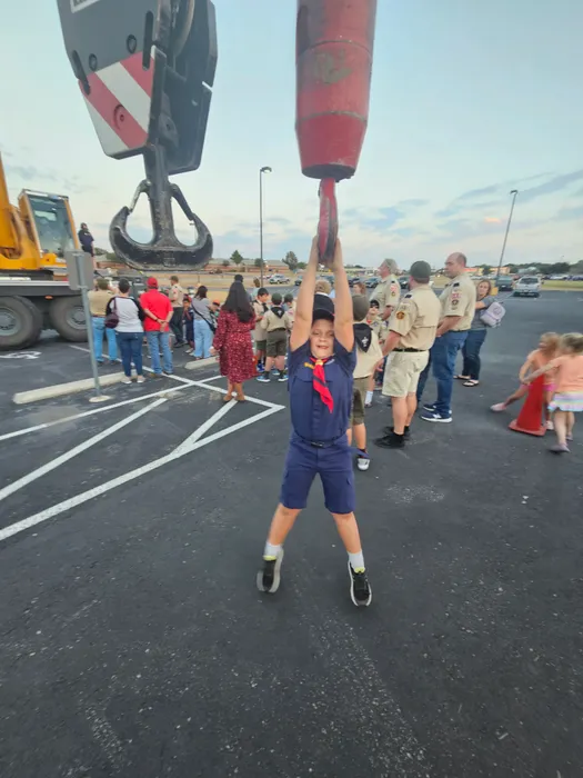 Wyatt reaching toward equipment at a group activity