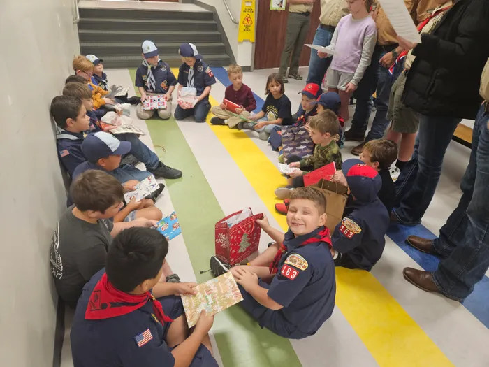 Scouts gathered around tables for a group activity